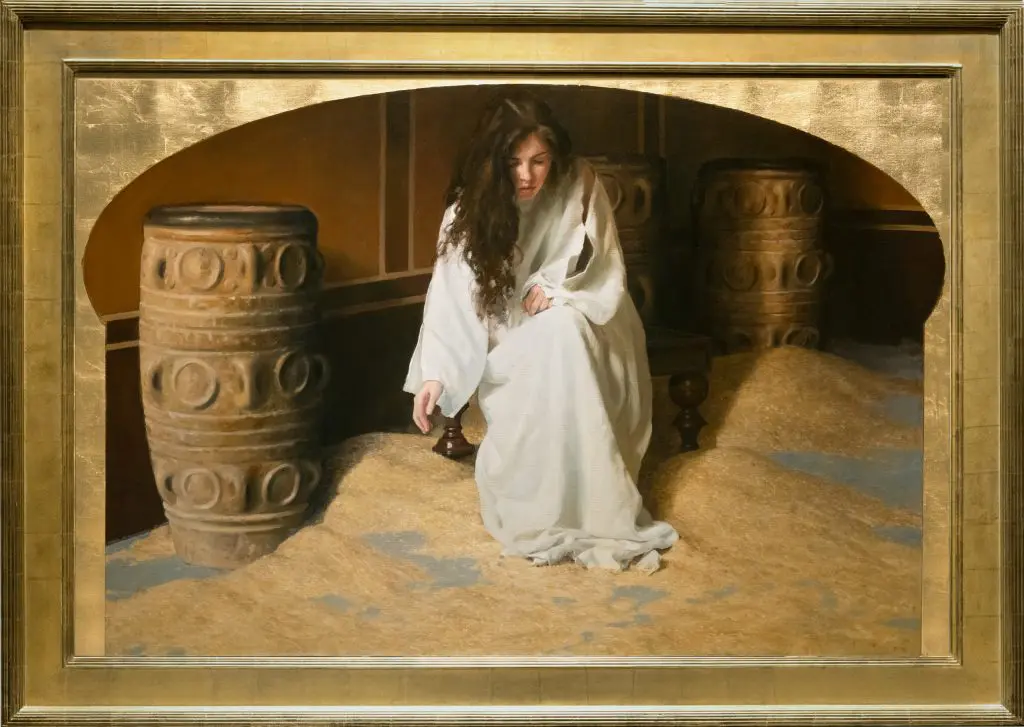 Woman wearing white gown sitting on a bench in a room with gold walls and barrels with piles of grain on the floor