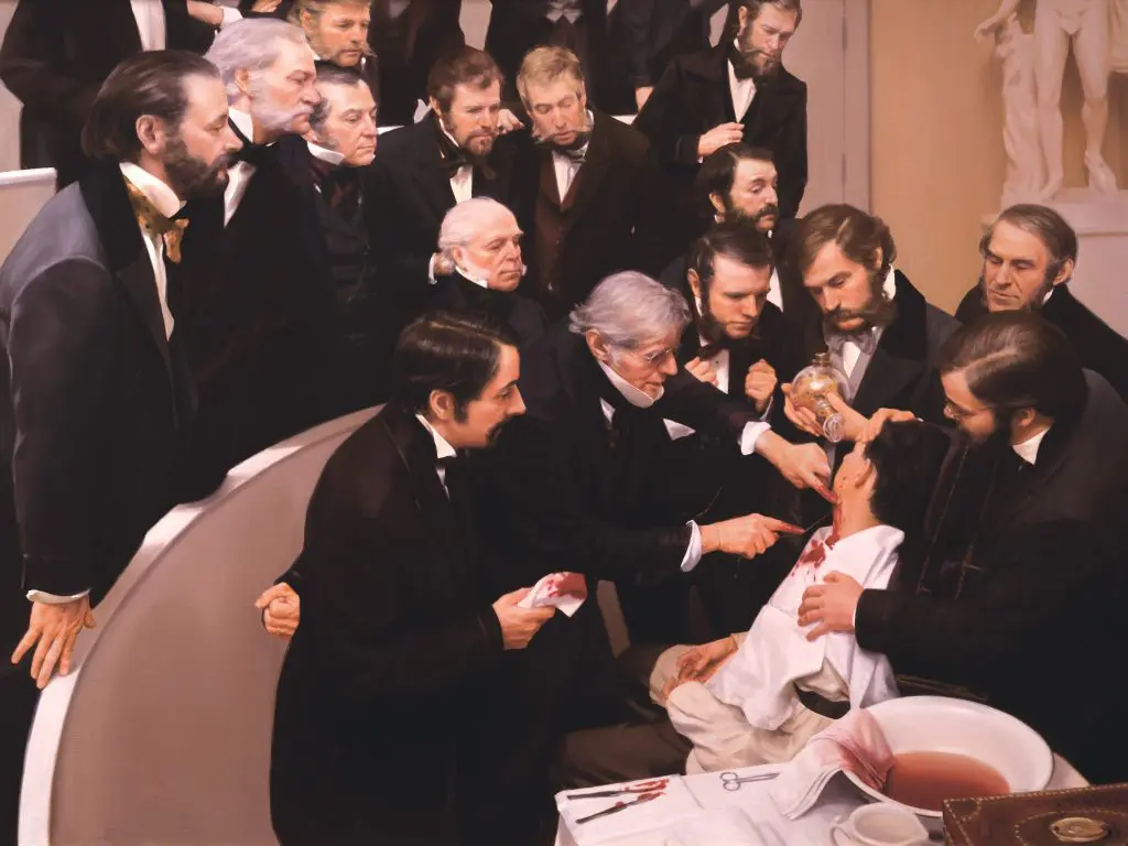 Several doctors standing an an auditorium watching the first surgery using ether as an anesthetic