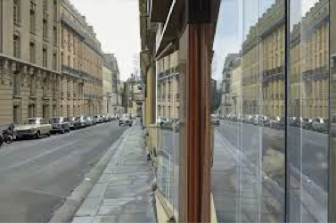 View of a city in the reflection of a large glass window