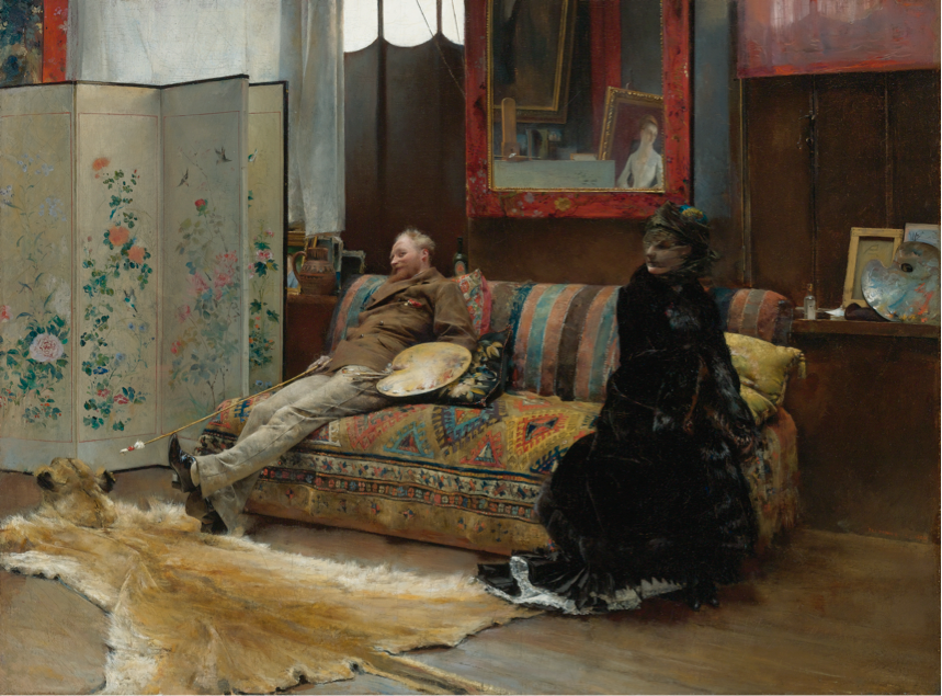 Man and women sitting on a couch in an eccentrically decorated room with paintings and a lion skin rug