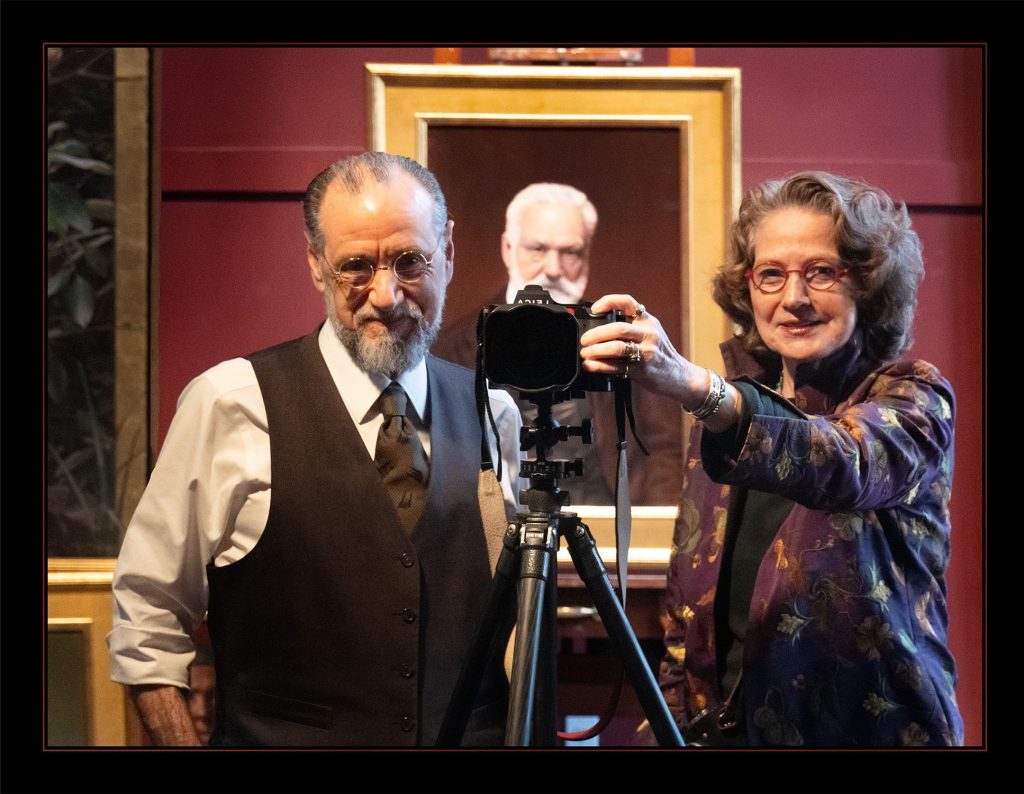 Warren and Lucia Prosperi standing in their studio taking a photo in a mirror